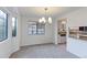 Bright dining area with large windows, chandelier, and a view into the kitchen at 4877 Darwin Ct, Boulder, CO 80301