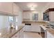Bright kitchen with granite countertops, white cabinets and a view to dining area at 4877 Darwin Ct, Boulder, CO 80301