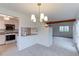 Open-concept kitchen with granite countertops, white cabinetry, and modern appliances at 4877 Darwin Ct, Boulder, CO 80301