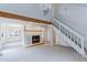Bright living room featuring a fireplace, wood beam, staircase, and ample natural light at 4877 Darwin Ct, Boulder, CO 80301