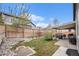 Landscaped backyard features a stone patio, lush lawn, and privacy fence at 9705 Westbury Cir, Highlands Ranch, CO 80129