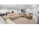 Large finished basement living area featuring a comfortable seating arrangement and staircase at 9705 Westbury Cir, Highlands Ranch, CO 80129