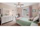 Serene bedroom features a desk, shelving, natural light, and closet space at 9705 Westbury Cir, Highlands Ranch, CO 80129