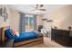 Cozy bedroom with natural light, built in shelving and a comfortable atmosphere at 9705 Westbury Cir, Highlands Ranch, CO 80129