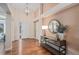 Bright foyer featuring hardwood floors, a stylish table, decor, and a decorative mirror at 9705 Westbury Cir, Highlands Ranch, CO 80129