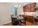 Bright breakfast nook features a round table and modern lighting at 9705 Westbury Cir, Highlands Ranch, CO 80129