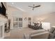 Inviting living room featuring a fireplace, vaulted ceilings, and a sliding glass door to the backyard at 9705 Westbury Cir, Highlands Ranch, CO 80129