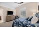 Comfortable main bedroom featuring a dresser with TV, chair, and natural light at 9705 Westbury Cir, Highlands Ranch, CO 80129