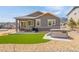 Cozy backyard with patio, seating area, artificial turf, and a luxurious hot tub at 4706 Mesa Top Dr, Monument, CO 80132