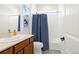 Clean bathroom with a single sink vanity, toilet and tub with shower at 4706 Mesa Top Dr, Monument, CO 80132