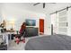 Bedroom boasts gray carpet, a ceiling fan, and red and black gaming chair at 4706 Mesa Top Dr, Monument, CO 80132