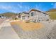 Charming single-Gathering home featuring a three-car garage, stone accents, and xeriscaped front yard at 4706 Mesa Top Dr, Monument, CO 80132