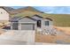 Charming home featuring a two-car garage, stone accents, and well-maintained landscaping at 4706 Mesa Top Dr, Monument, CO 80132