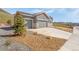Charming single-Gathering home featuring a three-car garage, stone accents, and xeriscaped front yard at 4706 Mesa Top Dr, Monument, CO 80132