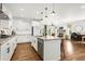 Bright, open kitchen with white cabinets, granite countertops, and stainless steel appliances at 4706 Mesa Top Dr, Monument, CO 80132