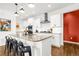 Bright, modern kitchen featuring an island with barstool seating, stainless steel appliances, and custom cabinets at 4706 Mesa Top Dr, Monument, CO 80132