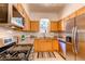 Functional kitchen with granite counters, stainless steel appliances, and ample cabinet space at 3206 Madison, Denver, CO 80205