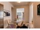 Eat-in kitchen area featuring a round glass table with four chairs, stylish accents, and natural light at 3206 Madison, Denver, CO 80205