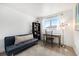 Bright, airy bedroom with a desk, futon, and large window offering scenic views at 7937 Chase Cir # 176, Arvada, CO 80003