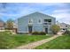 Charming two-story home with blue siding, landscaped front yard and lovely stone pathway at 7937 Chase Cir # 176, Arvada, CO 80003