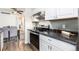 Updated kitchen with stainless steel appliances, white cabinets and modern mosaic backsplash at 7937 Chase Cir # 176, Arvada, CO 80003