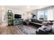 Well-lit living room featuring a modern entertainment center, large window, and comfortable seating at 7937 Chase Cir # 176, Arvada, CO 80003