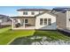 Beautiful backyard featuring artificial turf, a covered patio, and a modern outdoor grill at 2548 Horsehound Pl, Castle Rock, CO 80104