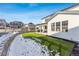 Landscaped backyard with artificial turf and a covered patio, ideal for relaxation and entertainment at 2548 Horsehound Pl, Castle Rock, CO 80104