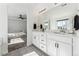 Bright bathroom with double vanity, modern fixtures, and a view into the Primary bedroom at 2548 Horsehound Pl, Castle Rock, CO 80104