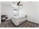 Neutral bedroom with a ceiling fan, carpet, and a window looking out to the neighborhood at 2548 Horsehound Pl, Castle Rock, CO 80104