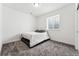 Carpeted bedroom with a small window and a simple bed frame at 2548 Horsehound Pl, Castle Rock, CO 80104