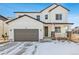 Charming two-story home with a white exterior, covered porch, and a two-car garage at 2548 Horsehound Pl, Castle Rock, CO 80104