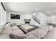 Cozy living room with a large sectional, fireplace, and a TV mounted on the wall at 2548 Horsehound Pl, Castle Rock, CO 80104