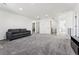 Expansive living room featuring neutral carpet, recessed lighting, and a view of the hallway at 2548 Horsehound Pl, Castle Rock, CO 80104