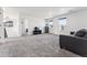 Bright living room with neutral carpet, a comfortable sofa, and large windows offering natural light at 2548 Horsehound Pl, Castle Rock, CO 80104