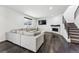 Comfortable living room featuring a large sectional, fireplace, and stairs leading upstairs at 2548 Horsehound Pl, Castle Rock, CO 80104