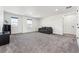 Spacious living room with neutral carpet, white walls, recessed lighting, and two windows at 2548 Horsehound Pl, Castle Rock, CO 80104