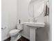 Clean powder room with white fixtures, vanity, and modern design at 2548 Horsehound Pl, Castle Rock, CO 80104