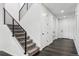 Modern staircase with black metal railing and neutral carpet leading to the upper level of the home at 2548 Horsehound Pl, Castle Rock, CO 80104