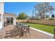 Backyard featuring a wooden deck with outdoor dining set and green lawn with privacy fence at 5872 Taft St, Arvada, CO 80004