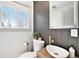 Stylish powder room with gray walls, a vessel sink, and a gold faucet at 5872 Taft St, Arvada, CO 80004