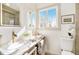 Bright bathroom with double sinks, modern fixtures, and large mirror at 5872 Taft St, Arvada, CO 80004