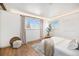 Bright bedroom with hardwood floors, neutral tones, and dual windows at 5872 Taft St, Arvada, CO 80004