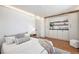 Bedroom with hardwood floors, built-in cabinets, shelves, and a cozy, neutral aesthetic at 5872 Taft St, Arvada, CO 80004