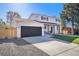Well-maintained home with a black garage door, a landscaped front yard, and inviting front porch at 5872 Taft St, Arvada, CO 80004