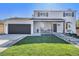 Charming two-story home featuring a well-manicured lawn, covered porch, and a two-car garage at 5872 Taft St, Arvada, CO 80004