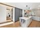 Modern kitchen features a large center island, stainless appliances, and ample cabinet space at 5872 Taft St, Arvada, CO 80004