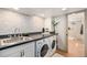 Functional laundry room with washer, dryer, ample countertop space, and neutral tones at 5872 Taft St, Arvada, CO 80004