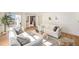 Bright living room with large window, neutral decor, wood floors and comfortable seating at 5872 Taft St, Arvada, CO 80004
