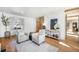 Comfortable living room with bay window features hardwood floors and neutral decor at 5872 Taft St, Arvada, CO 80004